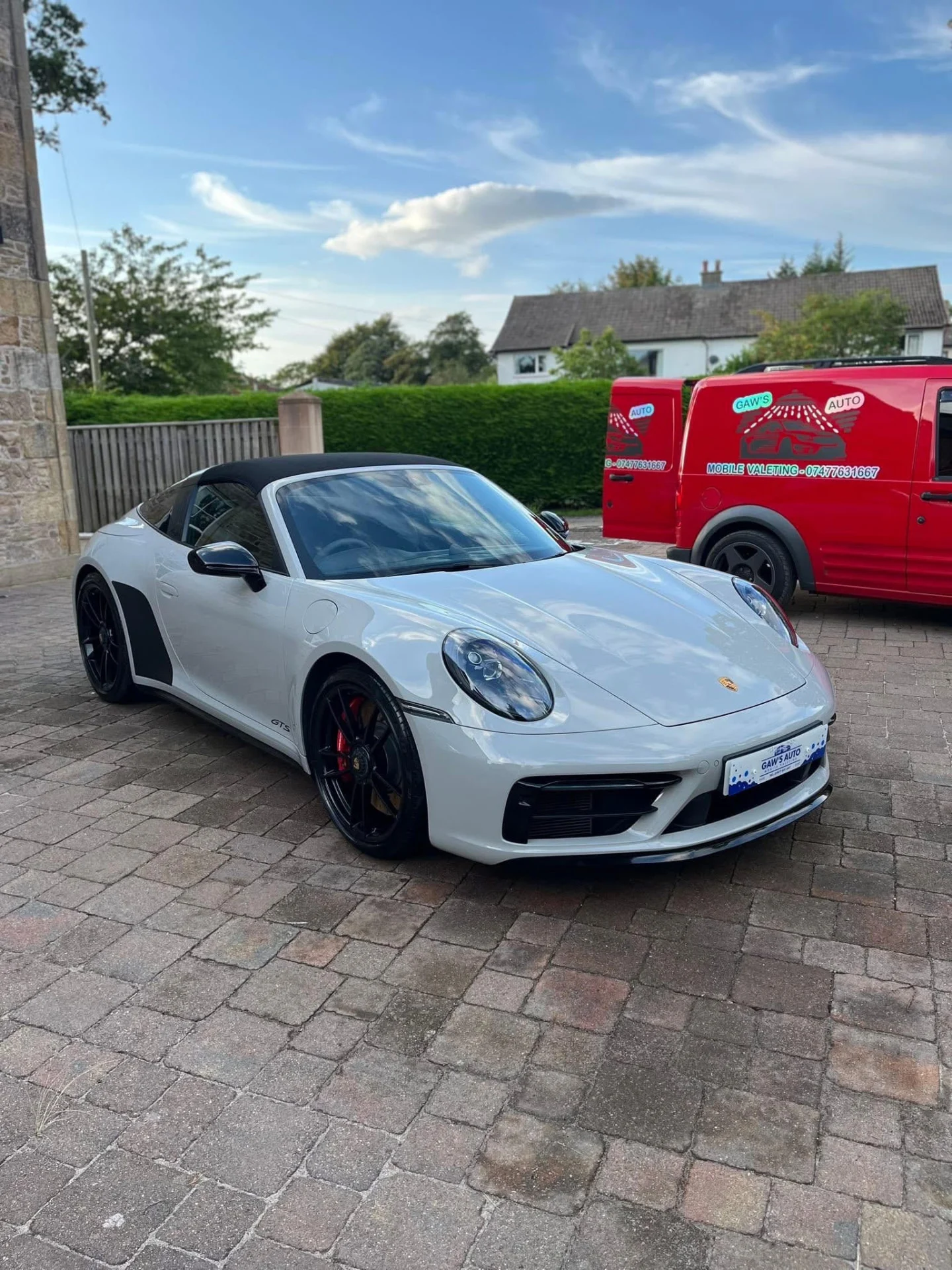 Finished white Porsche with the red Gaw’s Auto mobile valeting van behind it